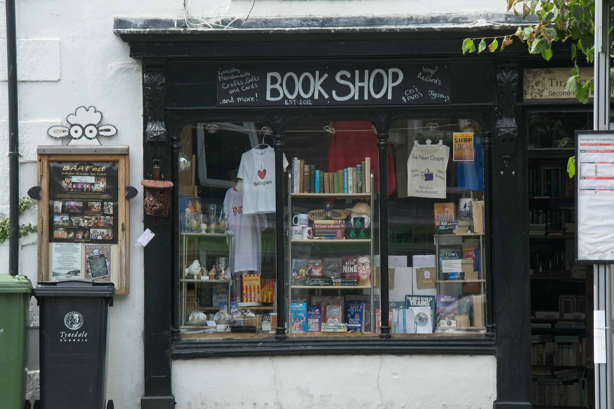 Exterior of a quaint bookshop in Bellingham, UK, showcasing a variety of books and gifts.